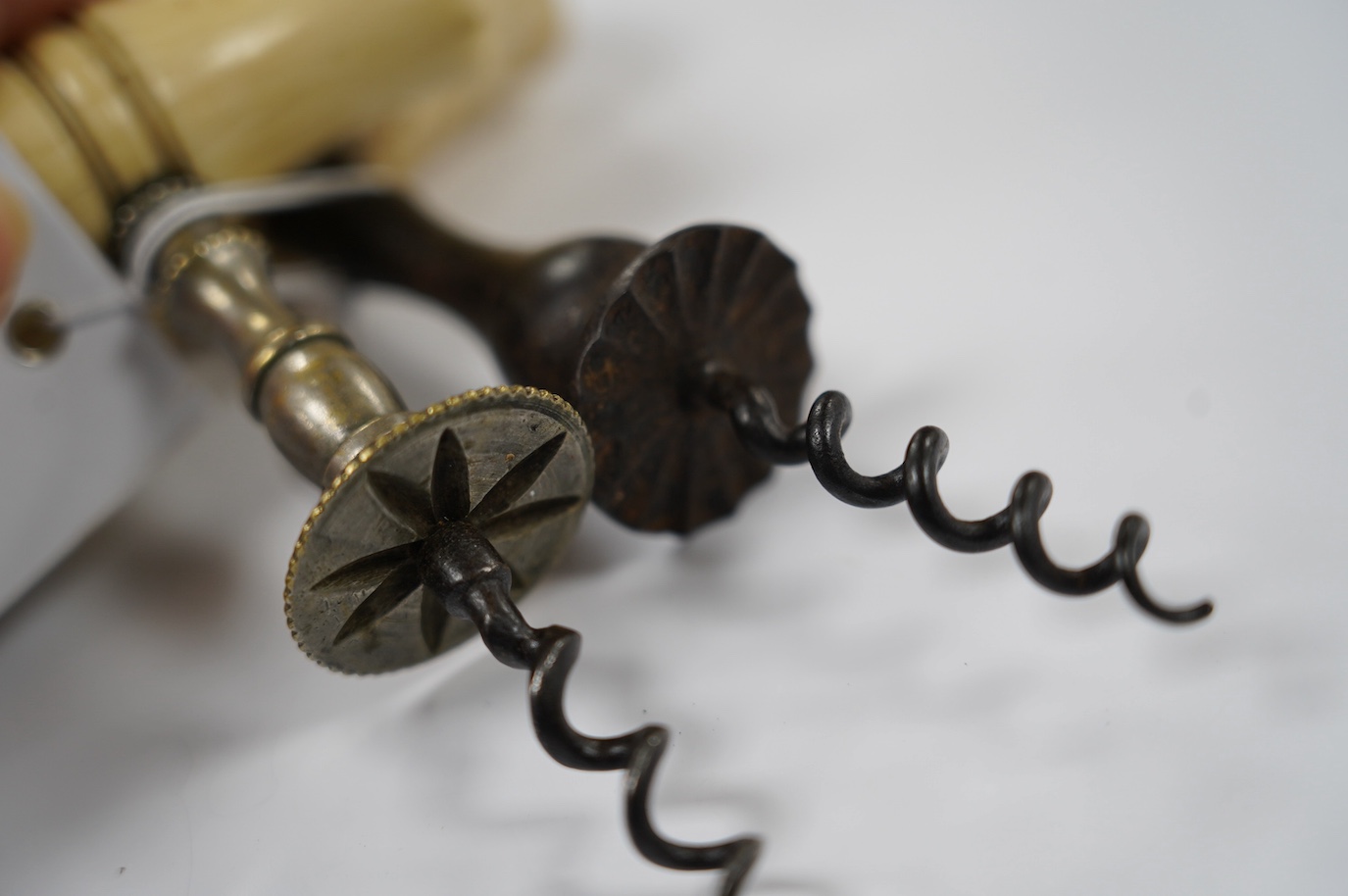 Two early 19th century bone handled corkscrews, one in steel with brush, the other in brass. Condition - good, brass example was silvered, small vacant hole to one end of the handle, no loop or ring